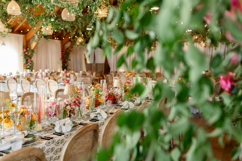 Summer camp wedding decorated with colorful florals and greenery.