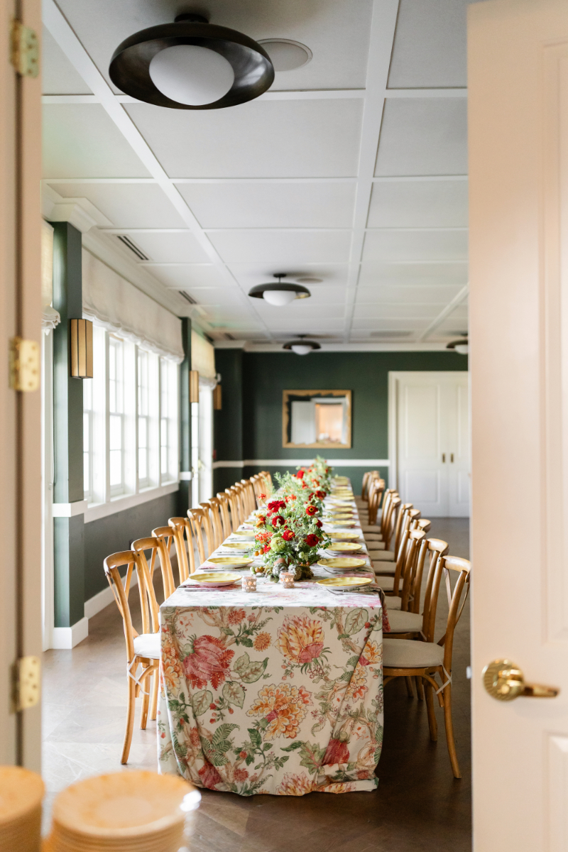 Heirloom tomato-inspired wedding welcome party tables set for guests.