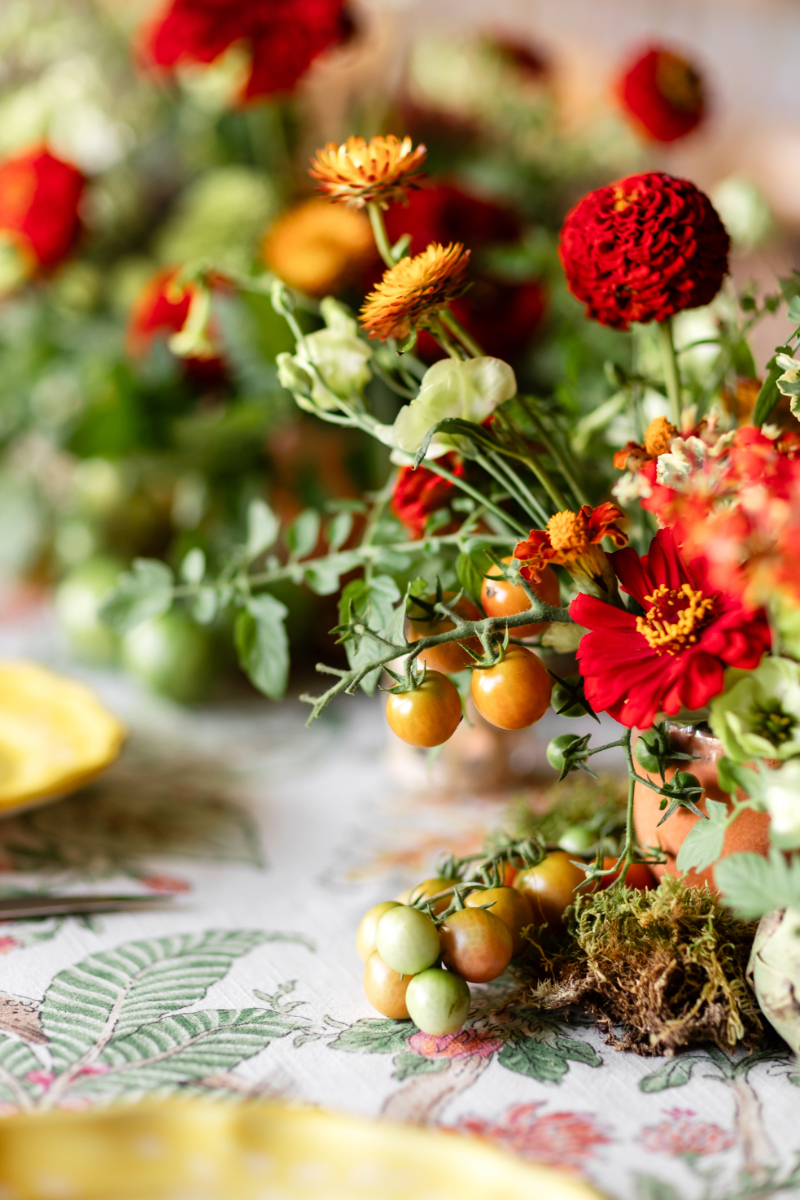 Heirloom tomato-inspired summer camp wedding welcome party floral arrangement.