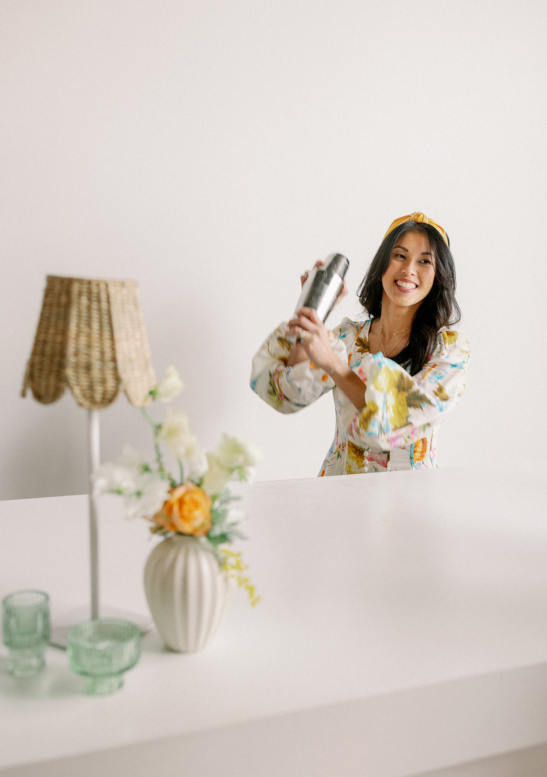 Wedding planner uses cocktail shaker to make custom drinks for her brand photos.