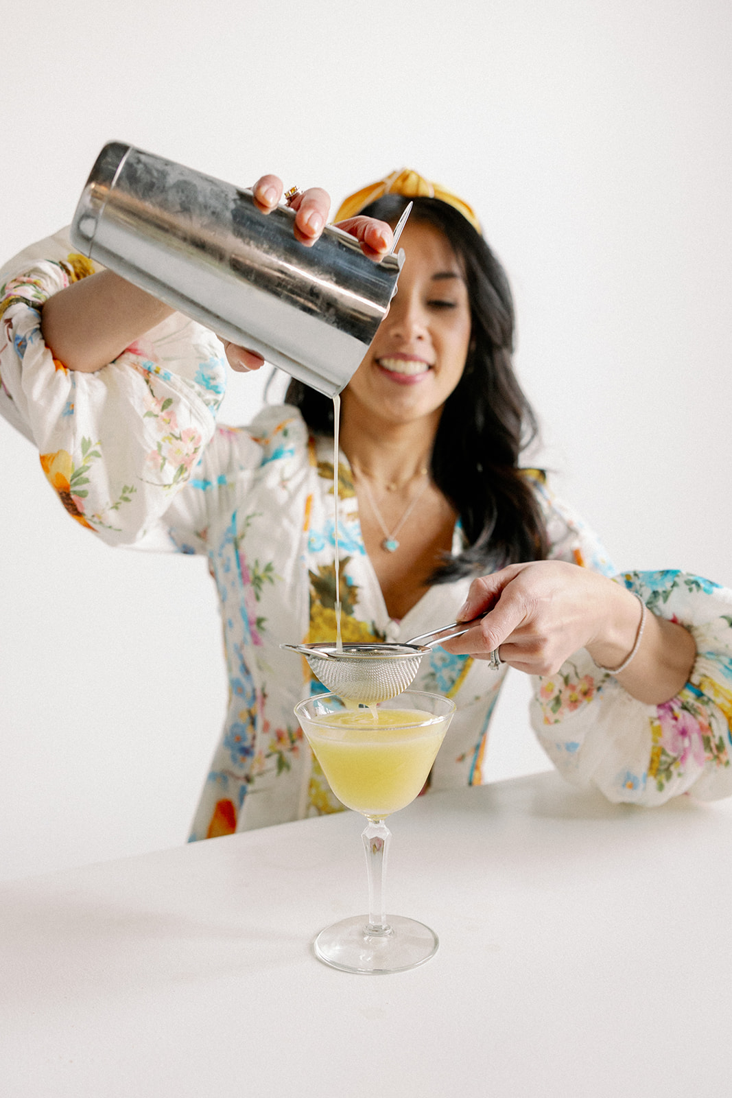 Wedding planner uses cocktail shaker to make custom drinks for her brand photos.