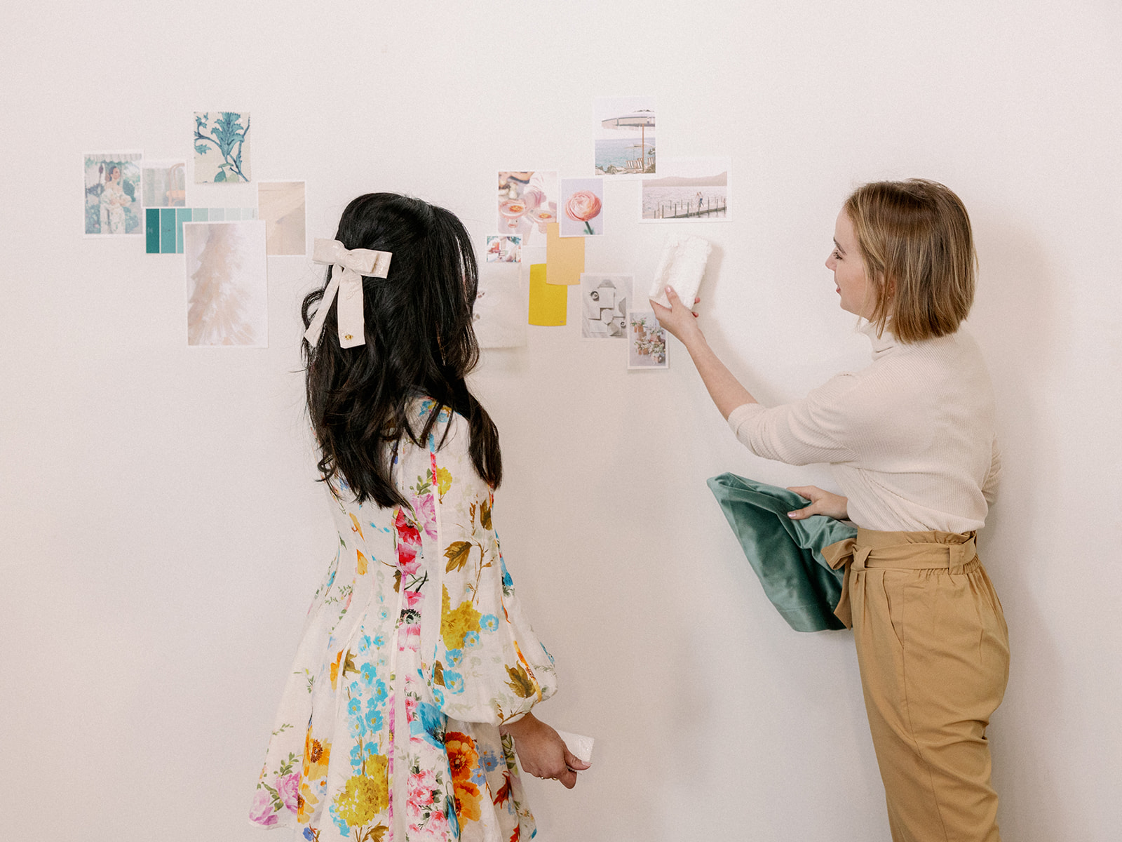 wedding planners place mood board on the wall to reference during setting up their style shoot wedding tablescape.