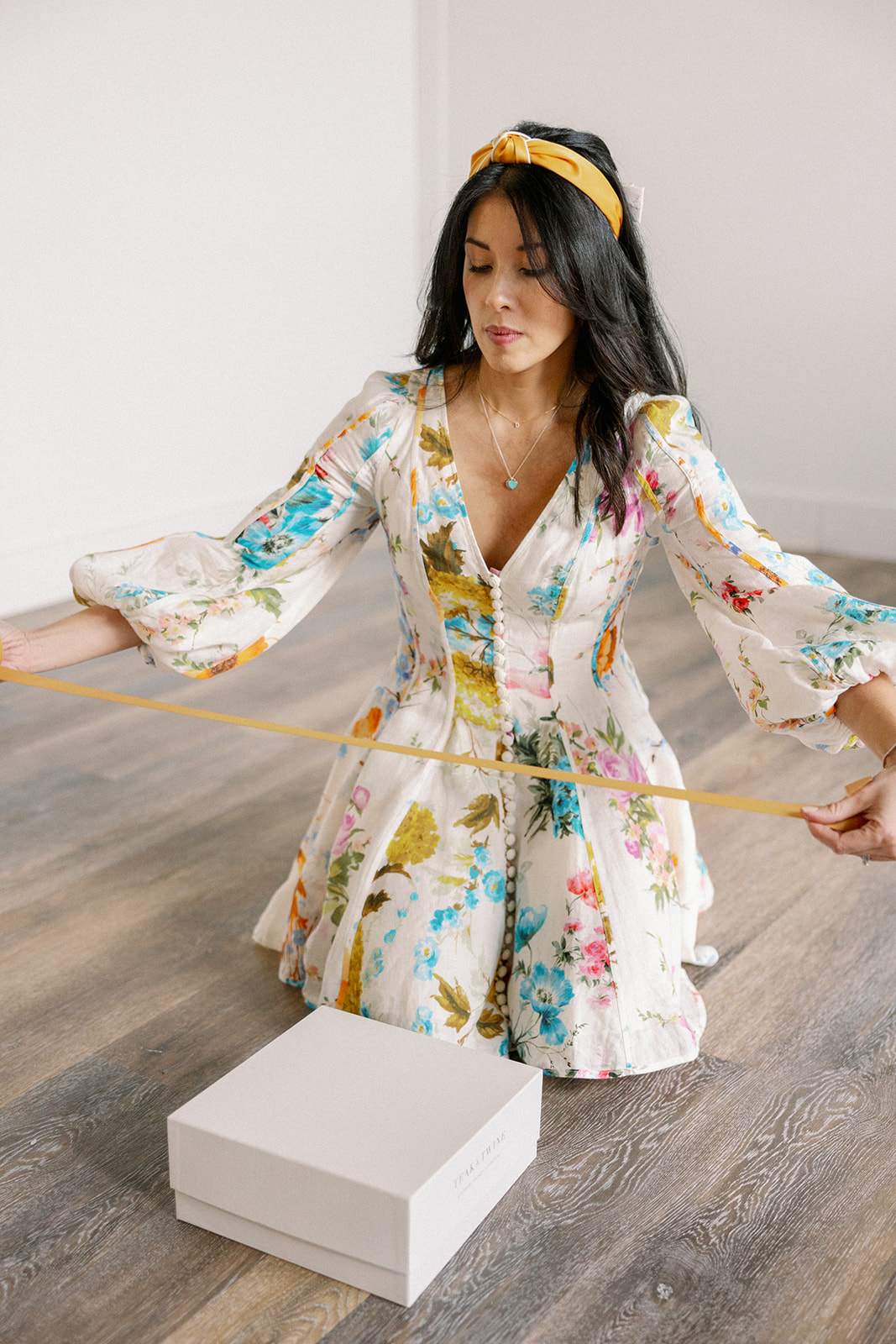 Wedding planner wraps white gift box with custom Verve Event Co. branded ribbon for her styled shoot wedding brand photos.