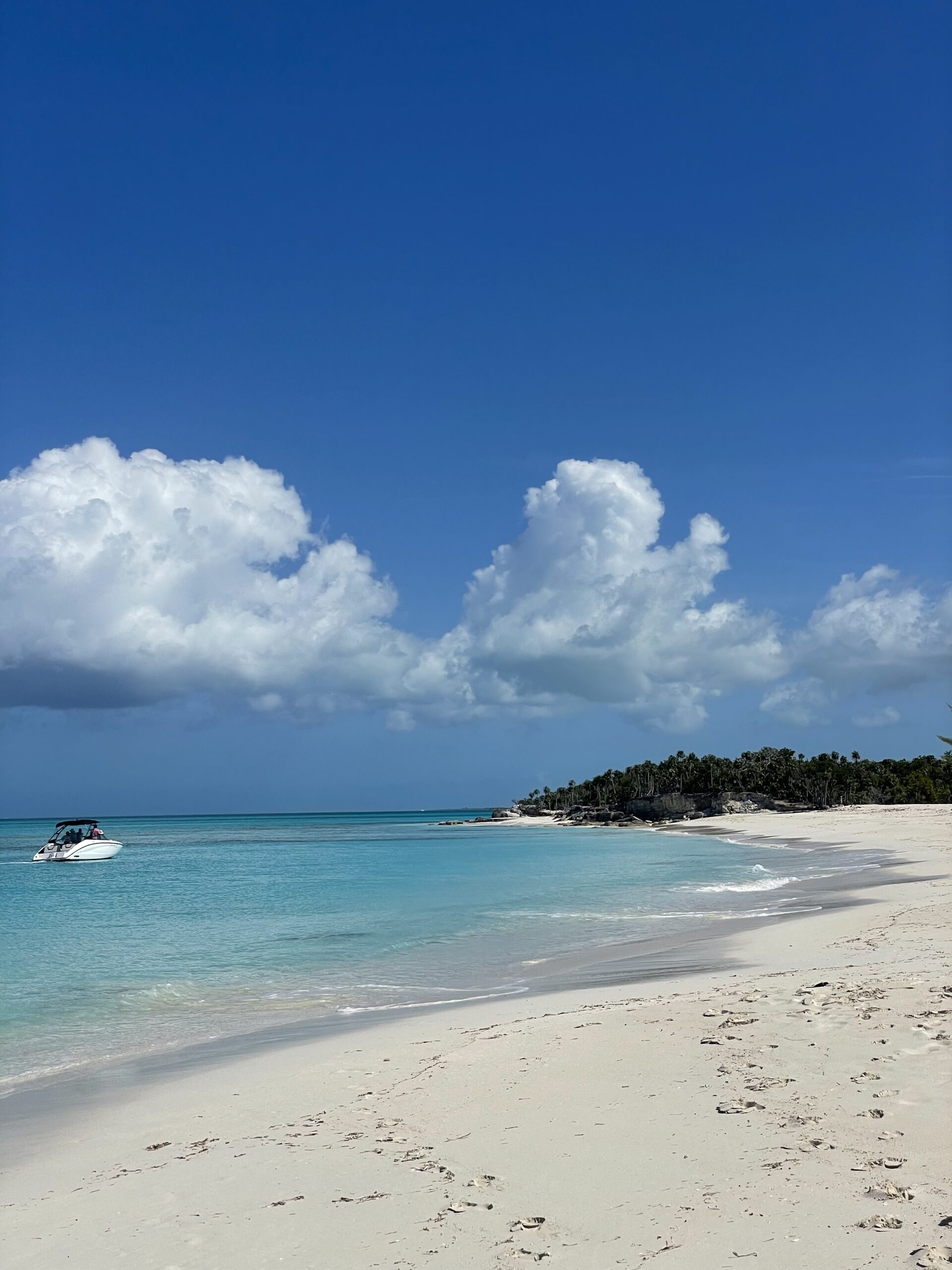 Clear blue waters of Turks & Caicos flowing up to the sand on the beach of all-inclusive destination weddings.