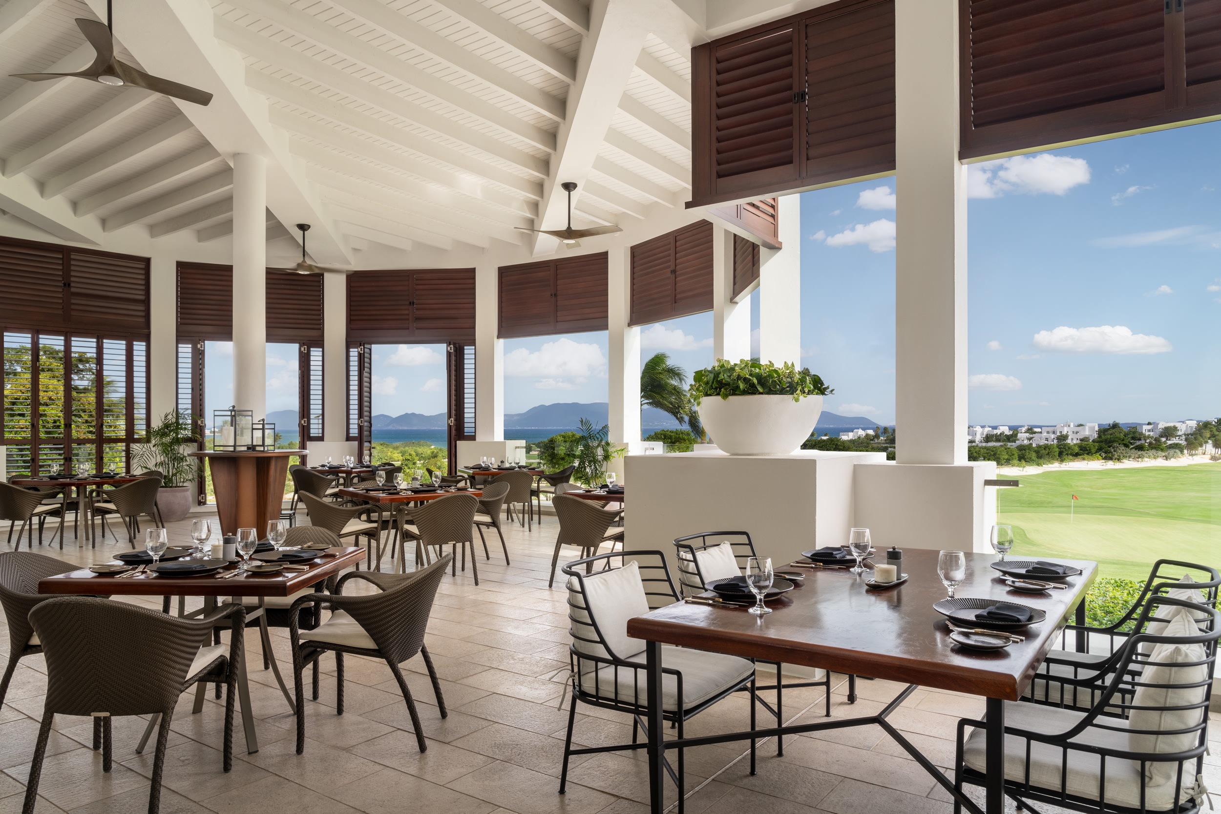 Dining overlooking the golf course and ocean at Aurora Anguilla.
