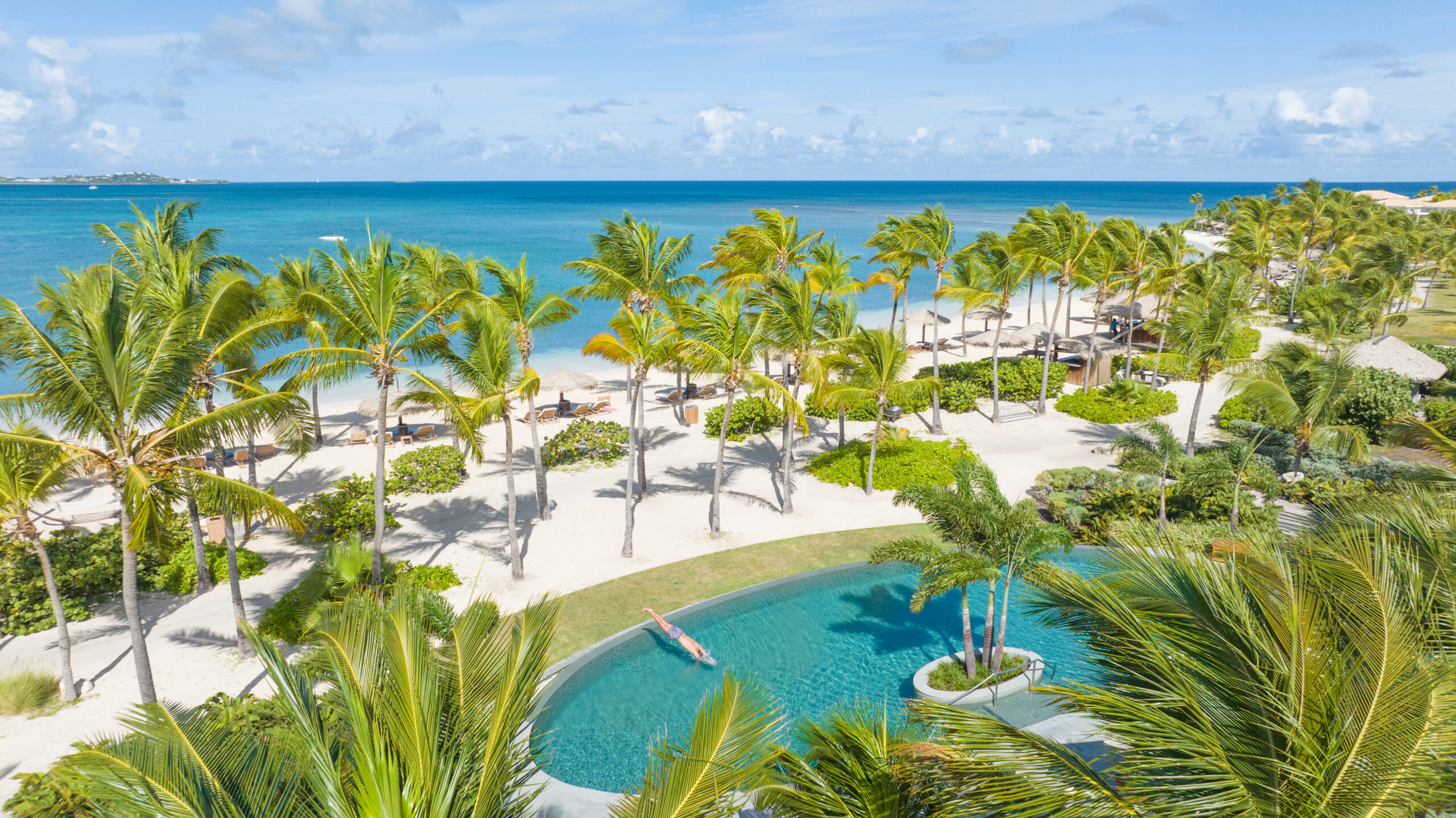 Jumby Bay resort pool just steps from the Caribbean.