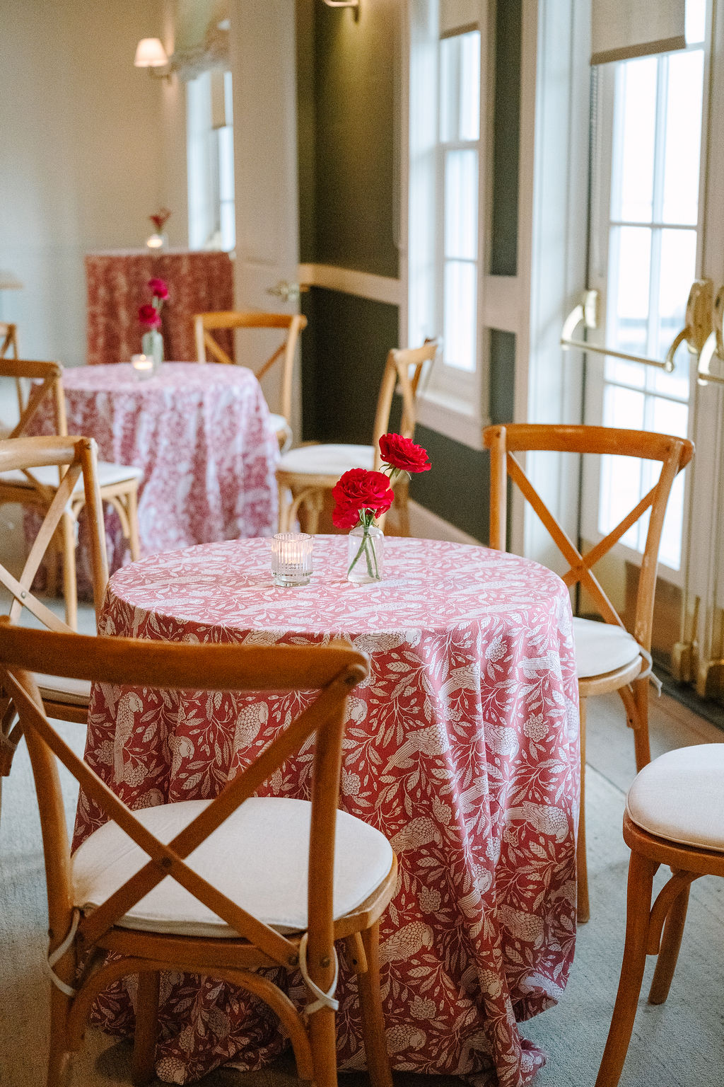 Cocktail hour tables decorated for a dutch-inspired spring wedding.