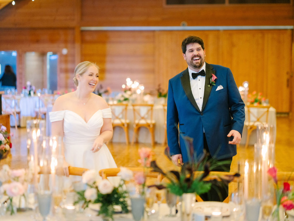 Bride and groom walk into their reception space for the first time, reacting to all the ideas they had for their dutch-inspired spring wedding come to life.