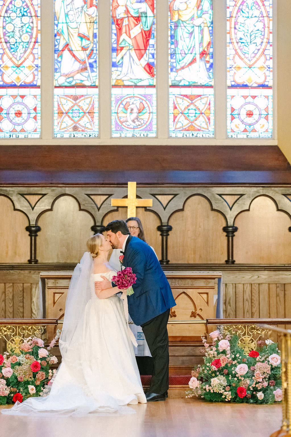 Bride and groom kiss at the end of wedding ceremony.